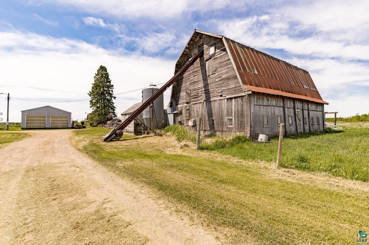 6606 Metso Road Kettle River, MN 55757 - Photo 35 of 84 Barn structure with weathered wood siding and a corrugated metal roof