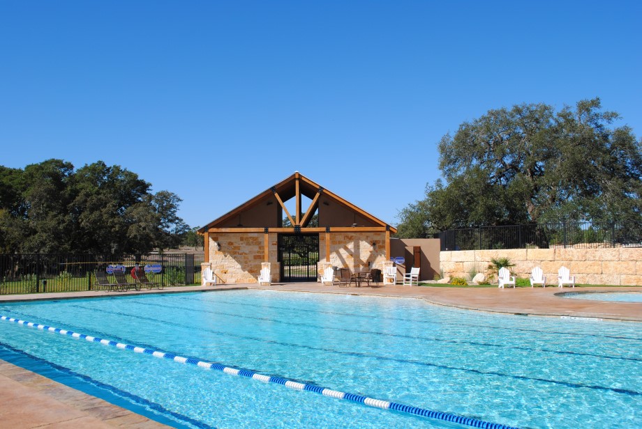 128 Hiram Cook Blanco, TX 78606 - Photo 38 of 40 An inviting pool area with a stylish stone-clad pavilion, perfect for leisurely afternoons.