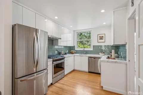 a kitchen with a sink stove and cabinets