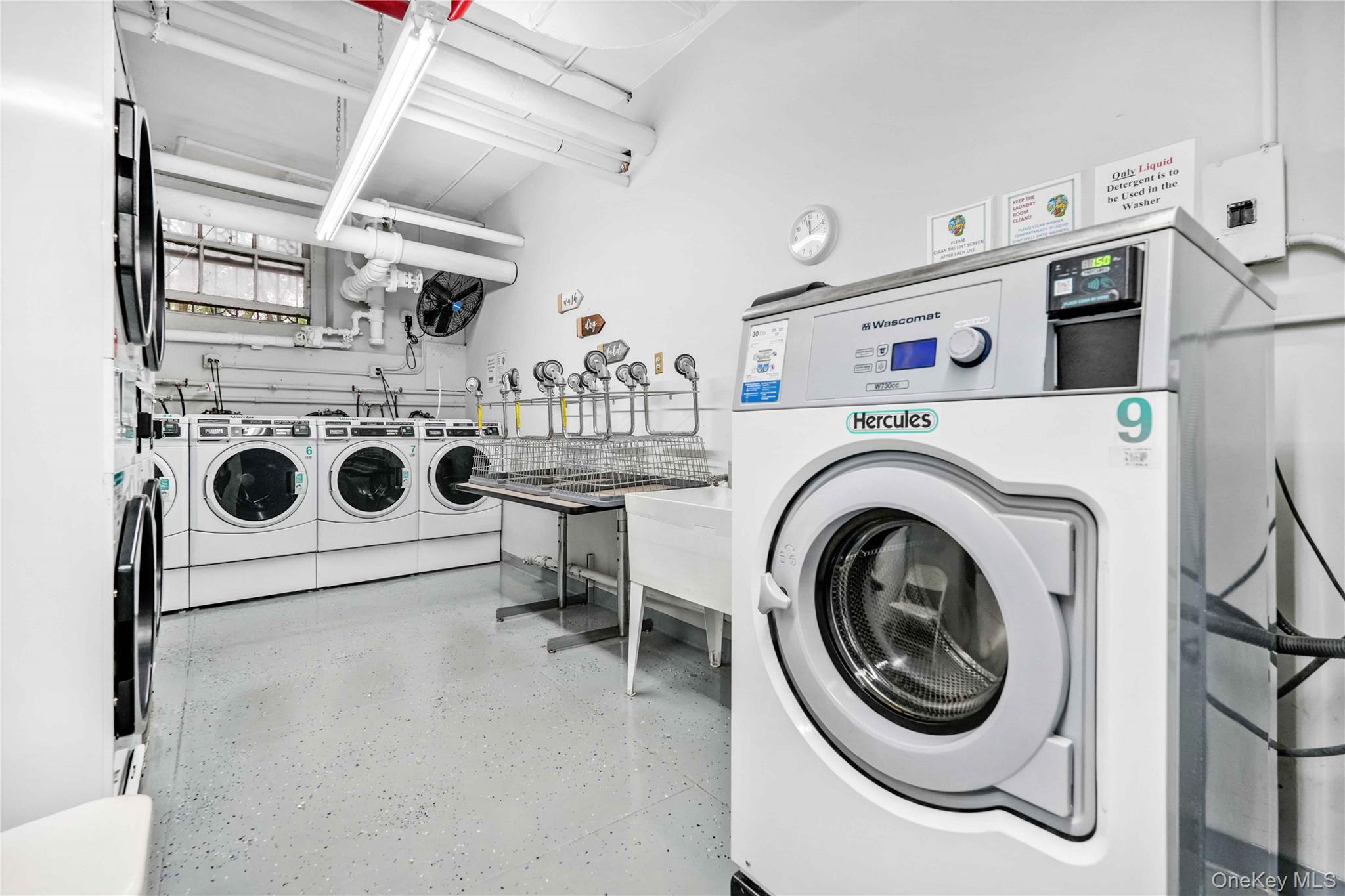 390 Riverside Drive, Unit 15D Manhattan, NY 10025 - Photo 11 of 18 Communal laundry room with washing machine and clothes dryer
