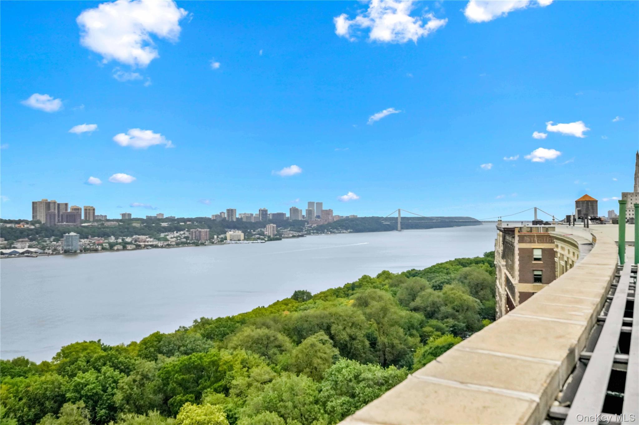 390 Riverside Drive, Unit 15D Manhattan, NY 10025 - Photo 26 of 29 Water view with city skyline and a notable bridge