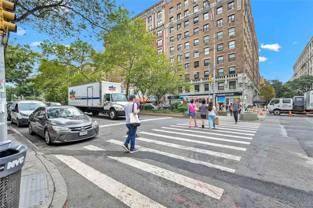a view of a city street lined with buildings and trees