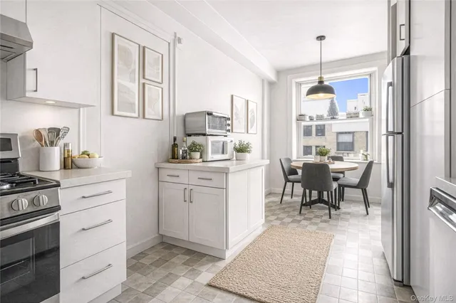 a kitchen with sink cabinets and stove top oven