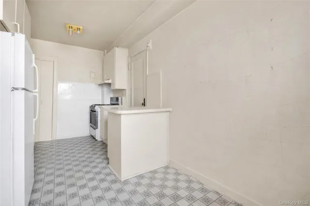 a utility room with cabinets washer and dryer