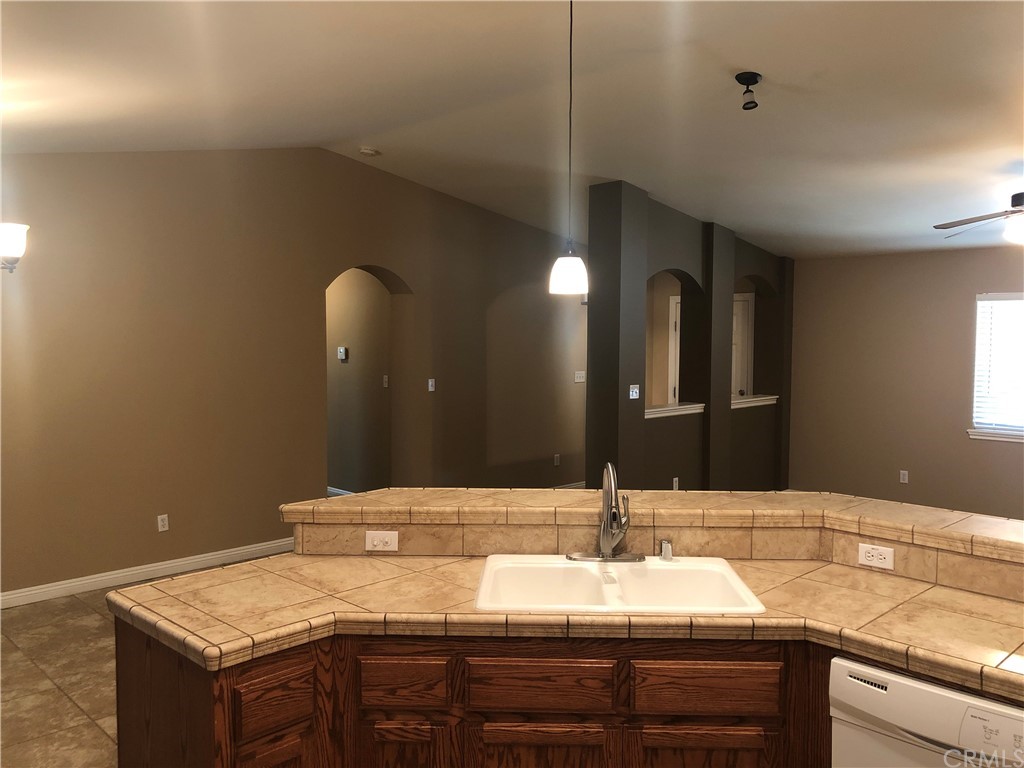 11612 Oasis Road Pinon Hills, CA 92372 - Photo 5 of 12 a bathroom with a granite countertop sink and a mirror