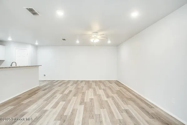 a view of kitchen cabinets and wooden floor