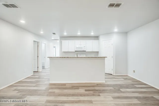 a view of kitchen with wooden floor