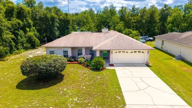 a view of house with garden space and swimming pool