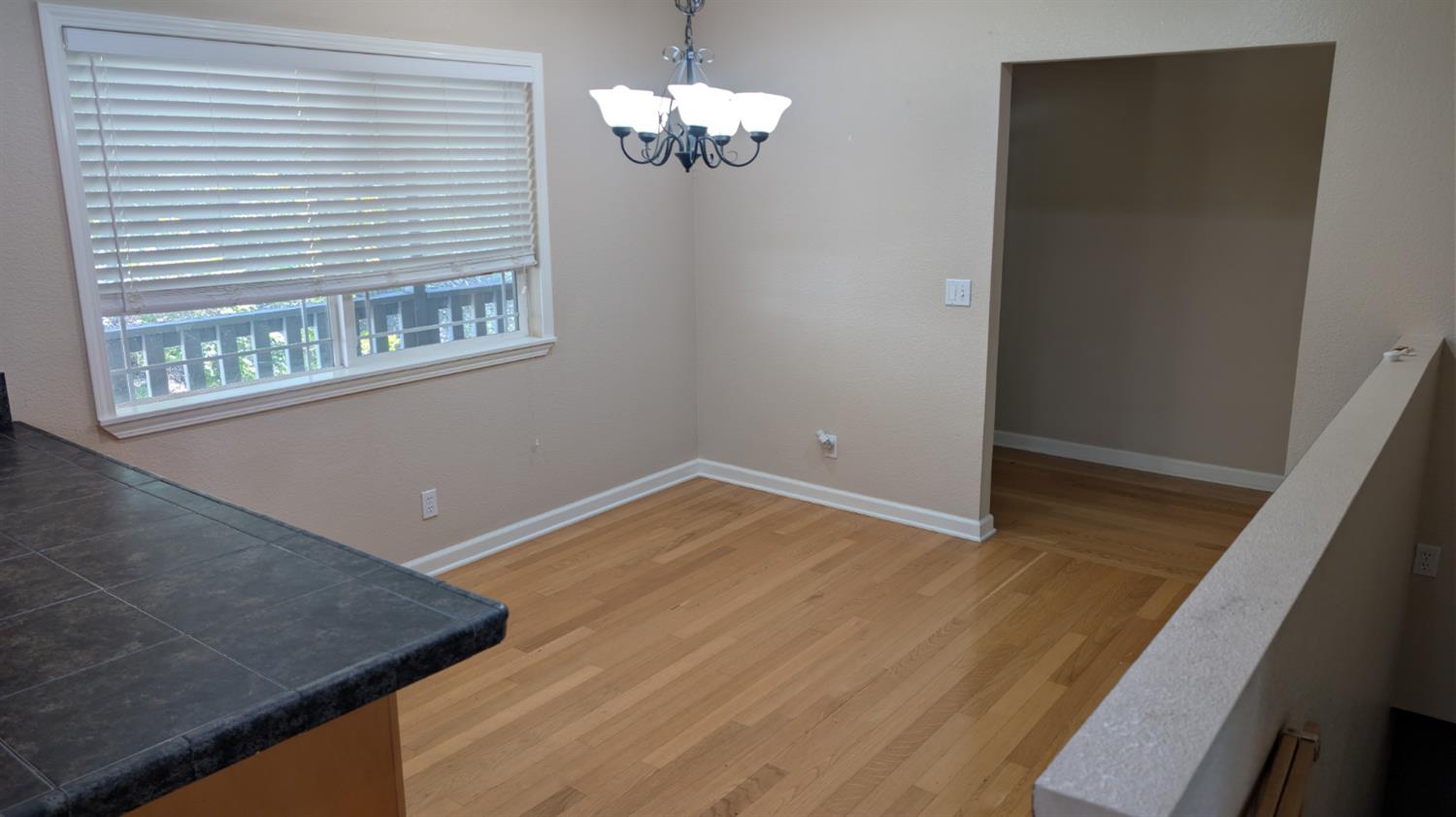 3248 Sudbury Road Cameron Park, CA 95682 - Photo 5 of 41 a view of a room with wooden floor and chandelier