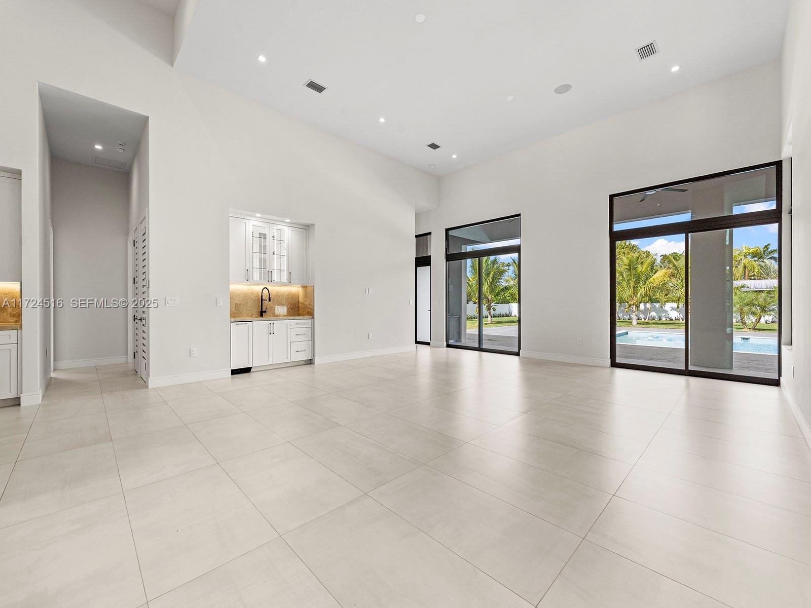 12025 Southwest 46th Street Miami, FL 33175 - Photo 11 of 45 an empty room with windows and view of bathroom