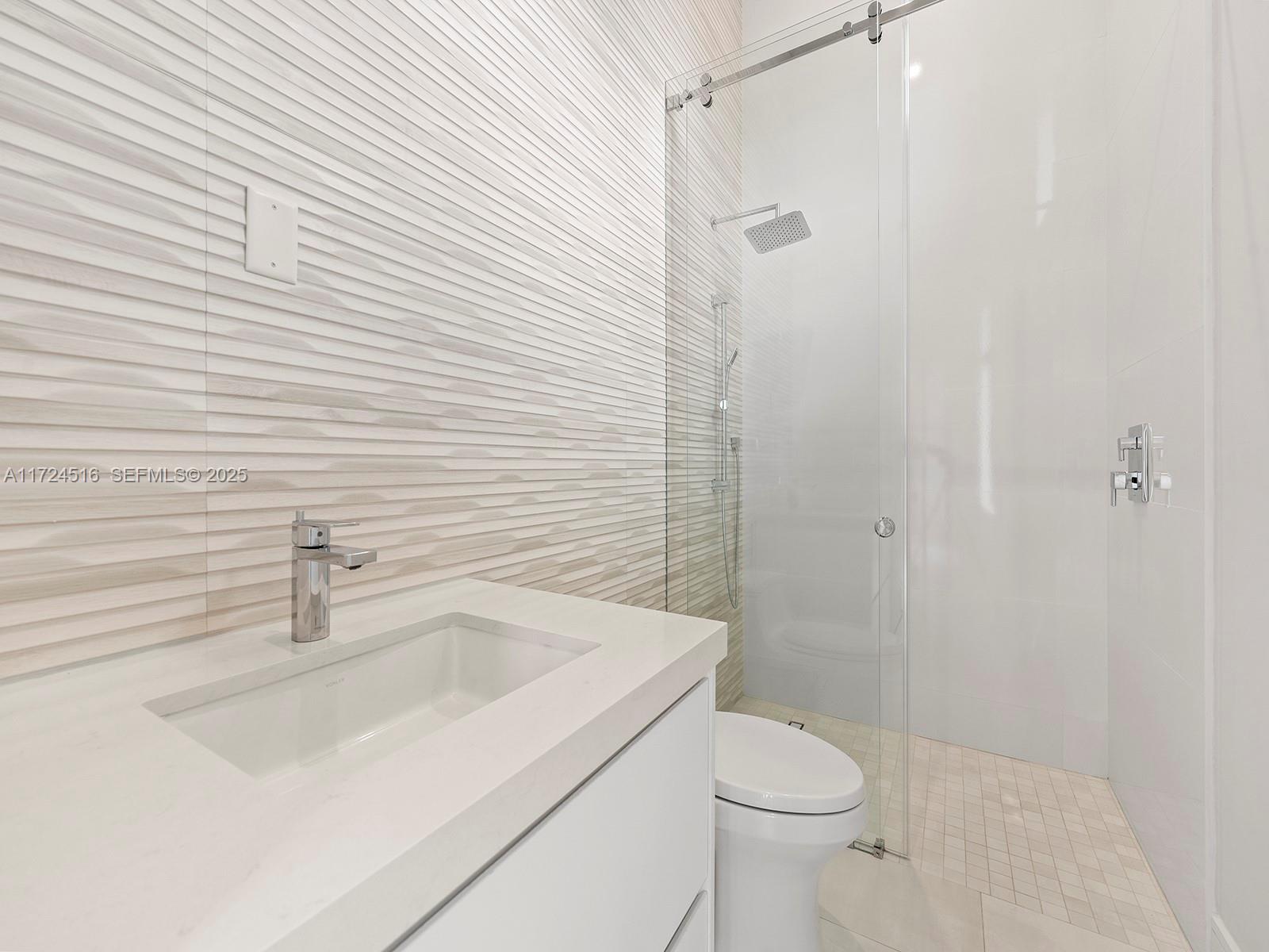 12025 Southwest 46th Street Miami, FL 33175 - Photo 26 of 45 a bathroom with a sink a toilet and shower