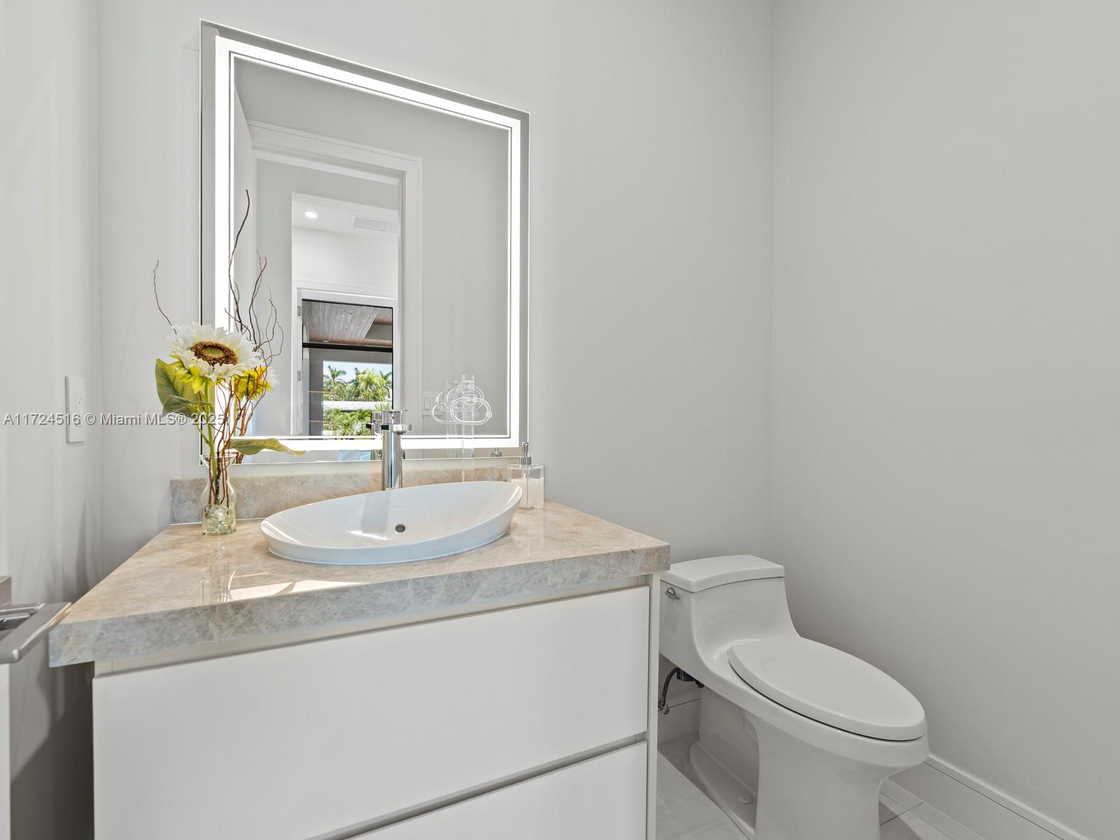 12025 Southwest 46th Street Miami, FL 33175 - Photo 28 of 45 a bathroom with a toilet sink and mirror