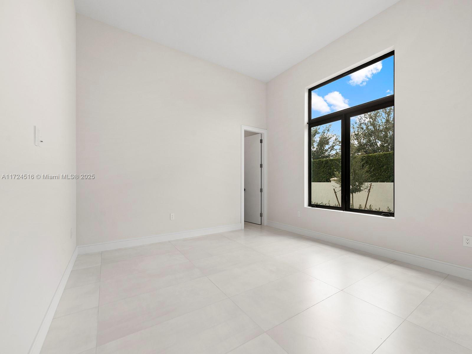 12025 Southwest 46th Street Miami, FL 33175 - Photo 29 of 45 a view of an empty room with a window