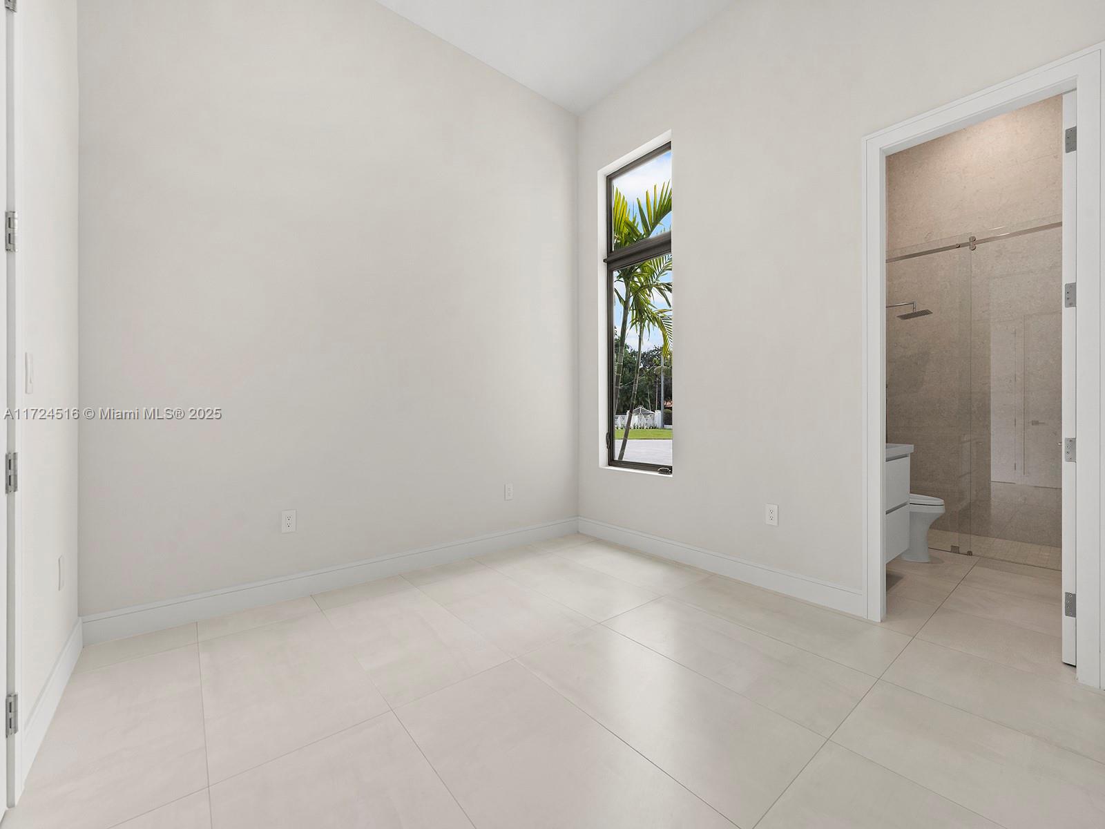 12025 Southwest 46th Street Miami, FL 33175 - Photo 30 of 45 an empty room with windows and entrance