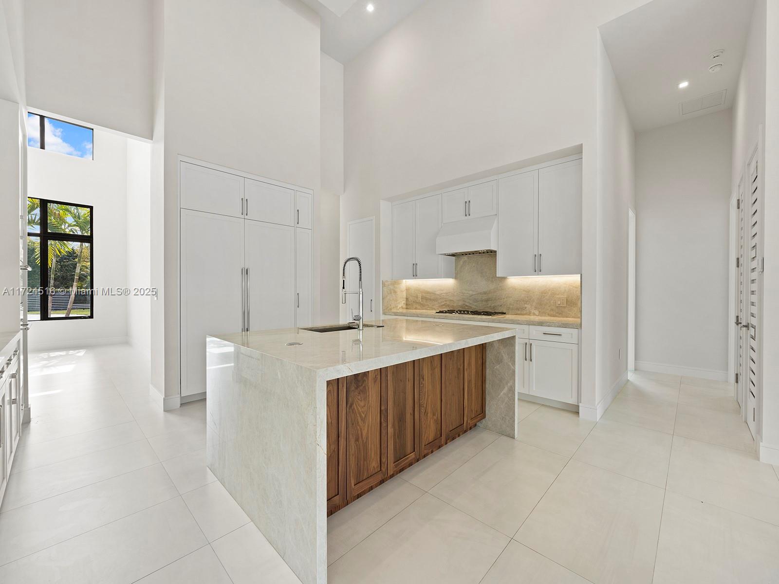 12025 Southwest 46th Street Miami, FL 33175 - Photo 8 of 45 a kitchen with kitchen island sink stove and refrigerator