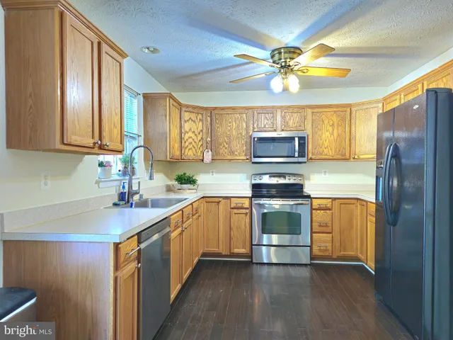 a view of a room with wooden floor and a window