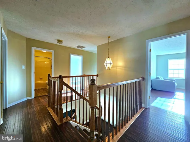 a view of a backyard with a garden and deck