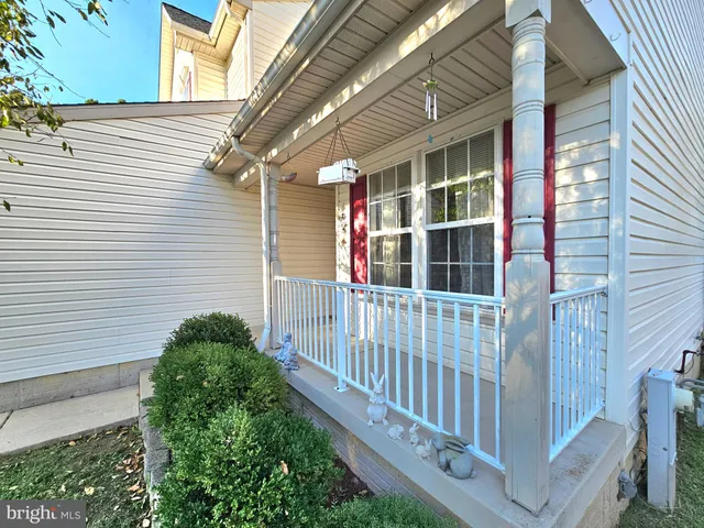 a view of a livingroom with wooden floor a fireplace and windows