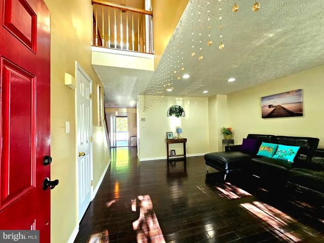 a kitchen with stainless steel appliances and wooden floor