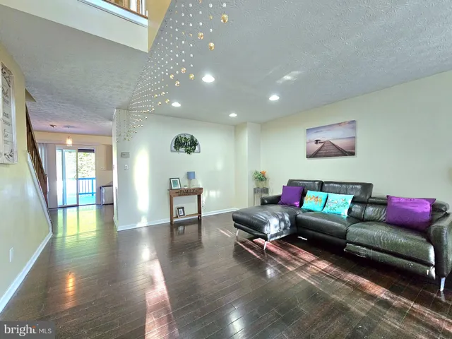 a view of bathroom with a sink mirror and wooden floor