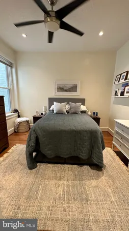a bedroom with a bed a window and couch