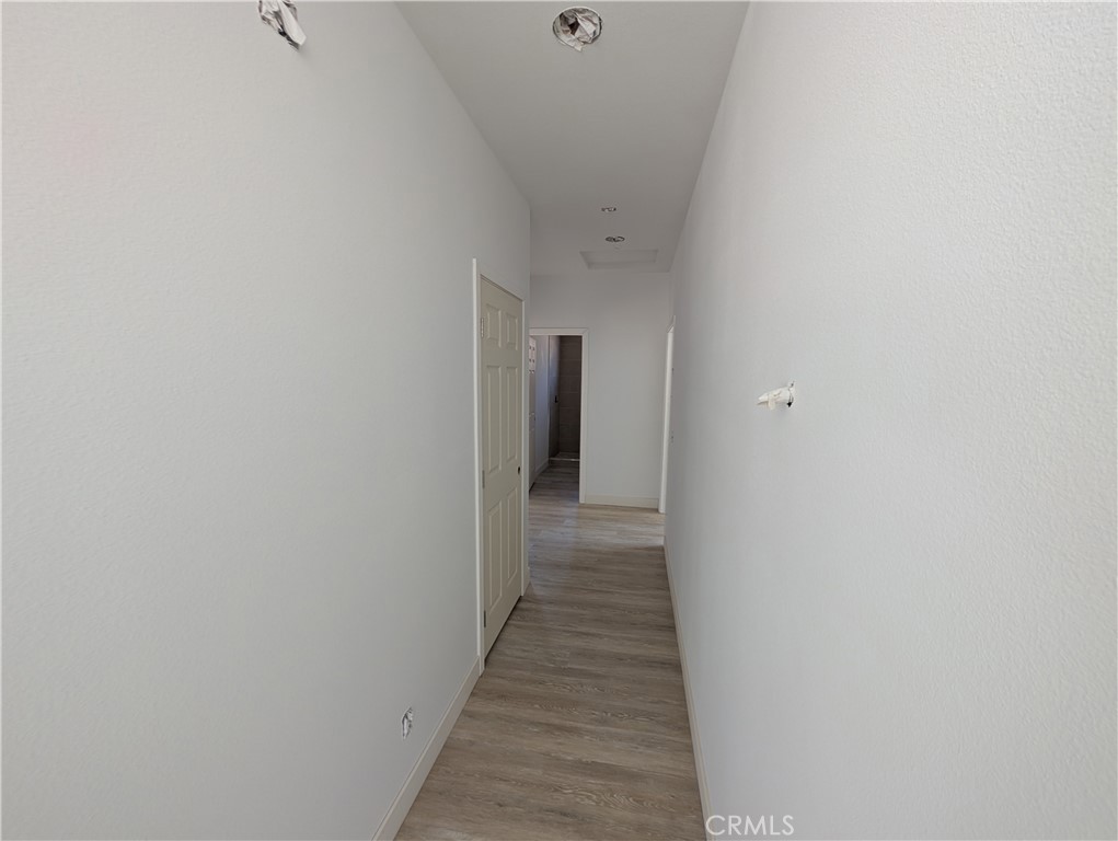 43145 Bob Cat Road Banning, CA 92220 - Photo 16 of 49 a view of a hallway with wooden floor