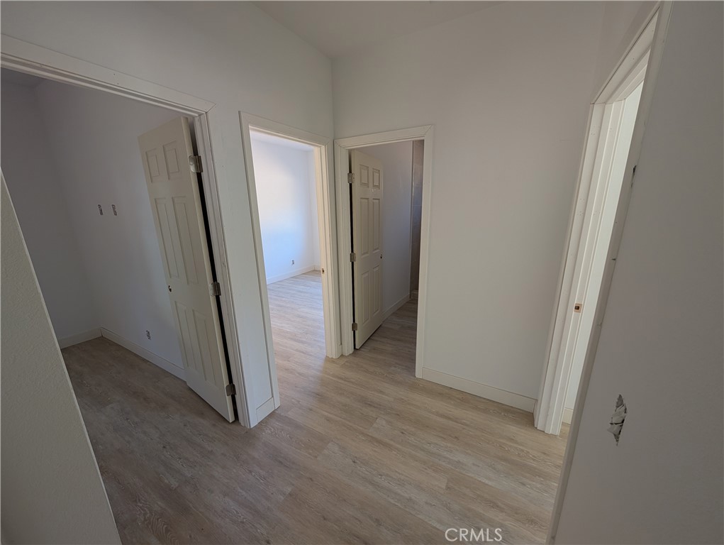 43145 Bob Cat Road Banning, CA 92220 - Photo 17 of 49 an empty room with wooden floor and a sink