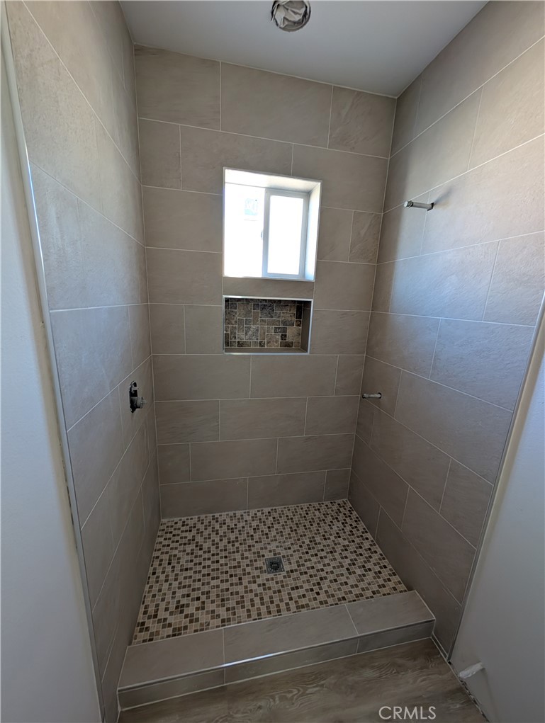 43145 Bob Cat Road Banning, CA 92220 - Photo 22 of 49 a bathroom with a sink a window and a shower