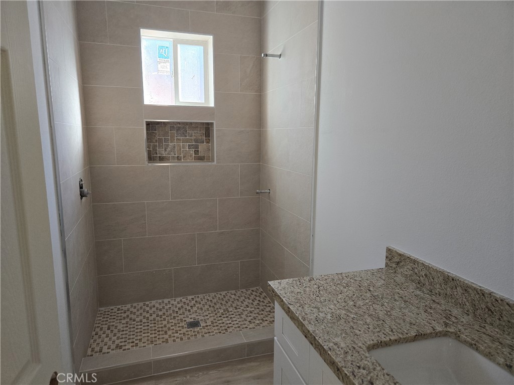 43145 Bob Cat Road Banning, CA 92220 - Photo 35 of 49 a bathroom with a granite countertop shower and vanity