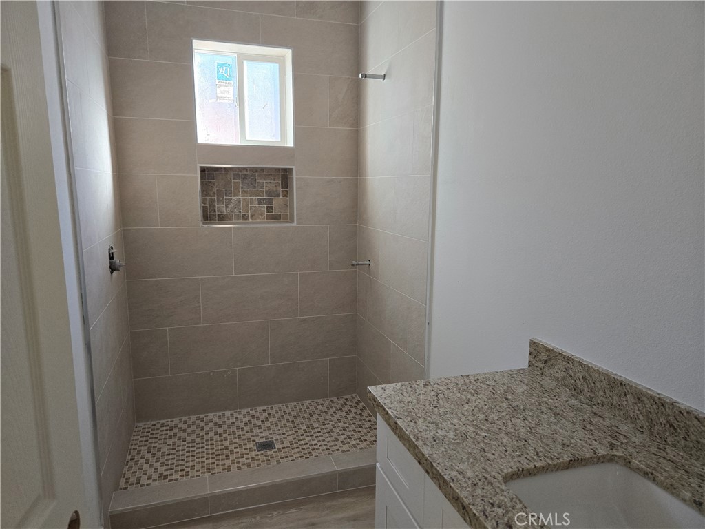 43145 Bob Cat Road Banning, CA 92220 - Photo 41 of 49 a bathroom with a granite countertop shower and vanity