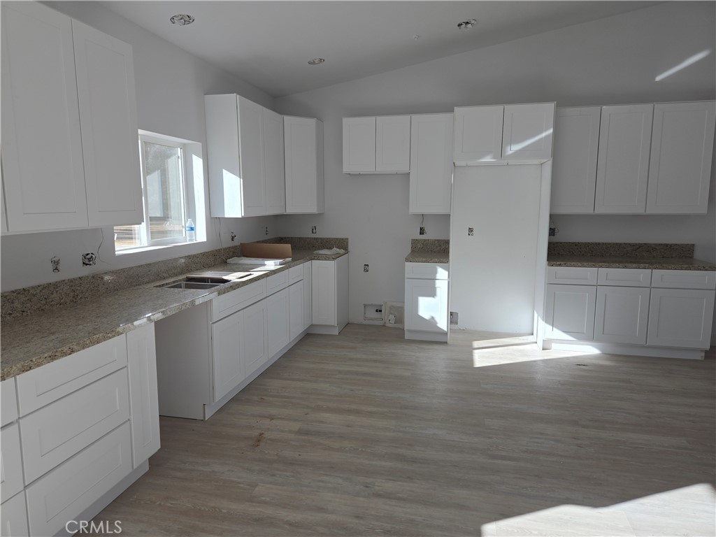 43145 Bob Cat Road Banning, CA 92220 - Photo 45 of 49 a kitchen with granite countertop a stove and a sink