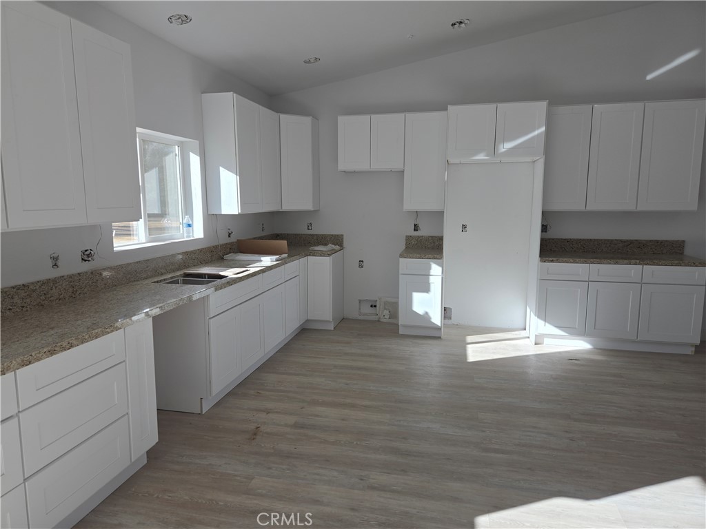 43145 Bob Cat Road Banning, CA 92220 - Photo 46 of 49 a kitchen with granite countertop a stove and a sink