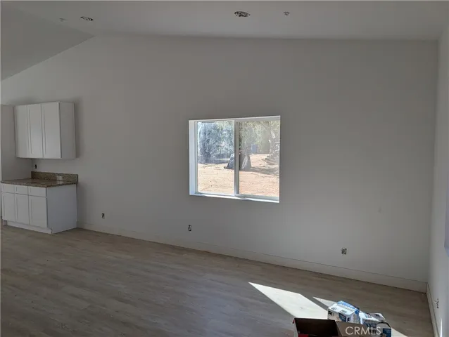 a view of a livingroom with wooden floor and window