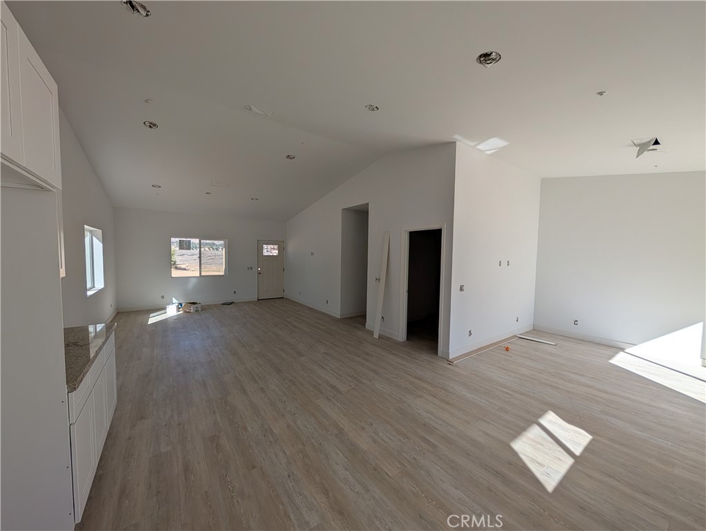 43145 Bob Cat Road Banning, CA 92220 - Photo 9 of 49 a view of a livingroom with wooden floor and window