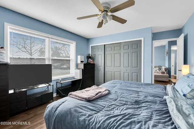 a bedroom with a bed dresser and a window