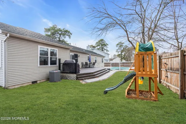 a view of a house with backyard and a slide