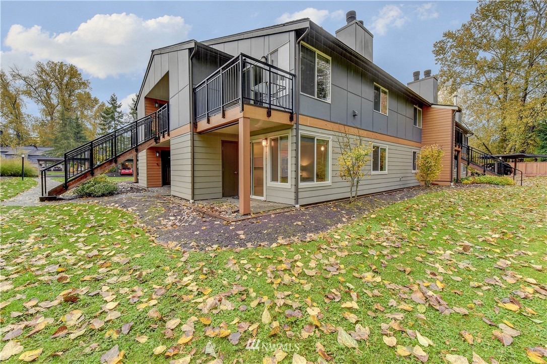 10831 Northeast 147th Lane, Unit R103 Bothell, WA 98011 - Photo 1 of 15 a front view of a house with a yard