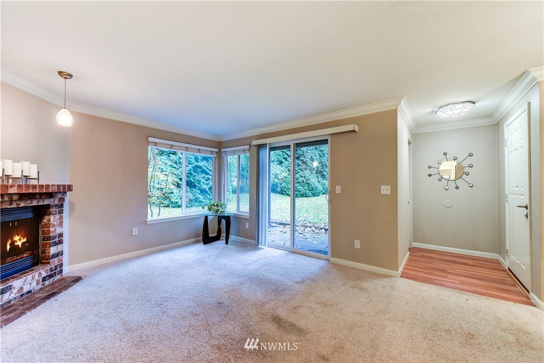 10831 Northeast 147th Lane, Unit R103 Bothell, WA 98011 - Photo 9 of 15 a view of an empty room with a fireplace and a window