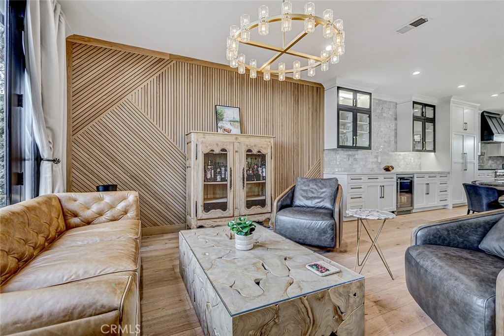 1852 6th Street Manhattan Beach, CA 90266 - Photo 22 of 60 a living room with furniture and a chandelier