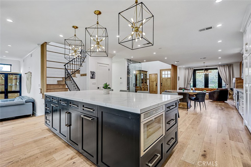 1852 6th Street Manhattan Beach, CA 90266 - Photo 30 of 60 a kitchen with stainless steel appliances granite countertop a sink a stove top oven a chimney and a chandelier