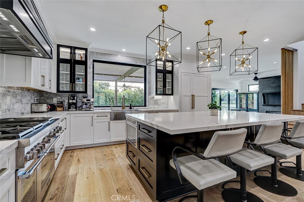 1852 6th Street Manhattan Beach, CA 90266 - Photo 31 of 60 a kitchen with stainless steel appliances granite countertop a sink stove and refrigerator