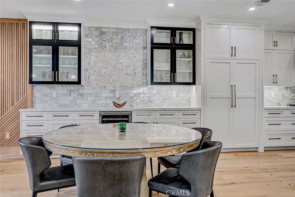 1852 6th Street Manhattan Beach, CA 90266 - Photo 37 of 60 a kitchen with stainless steel appliances a sink table and chairs