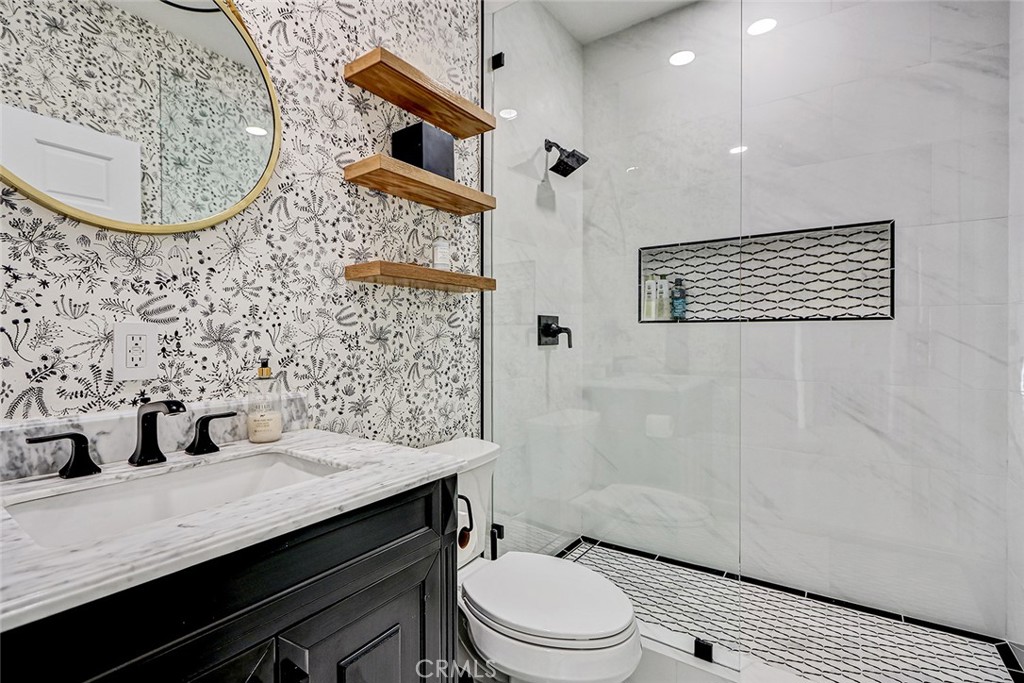 1852 6th Street Manhattan Beach, CA 90266 - Photo 51 of 60 a bathroom with a granite countertop sink a toilet and shower