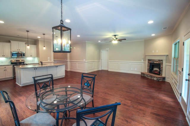 7600 Lynch Road Midland, GA 31820 - Photo 7 of 16 a living room with furniture a fireplace and a chandelier