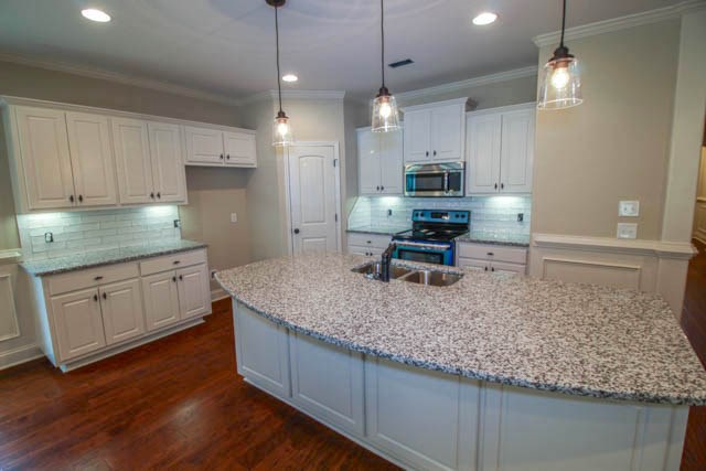 7600 Lynch Road Midland, GA 31820 - Photo 8 of 16 a kitchen with kitchen island granite countertop a sink a counter space stainless steel appliances and cabinets