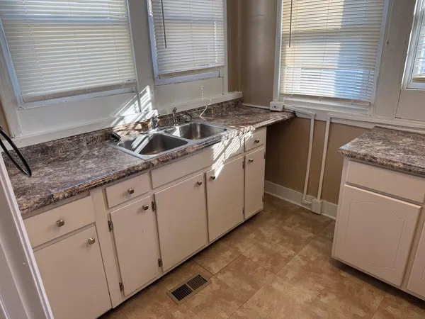 a kitchen with a sink stove and cabinets
