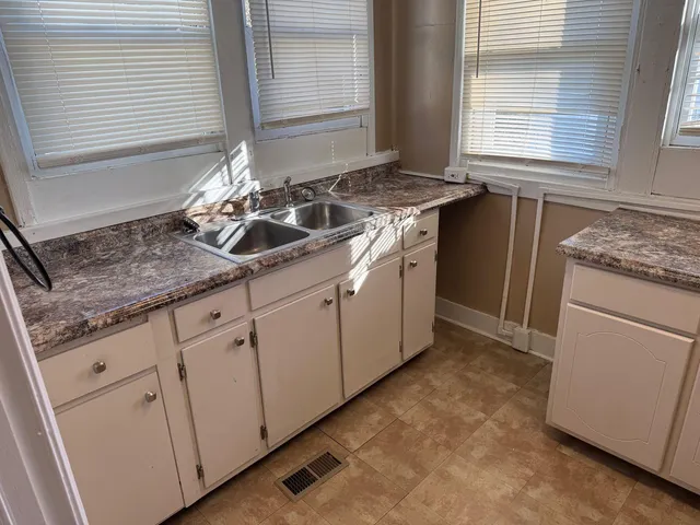 a kitchen with a sink stove and cabinets