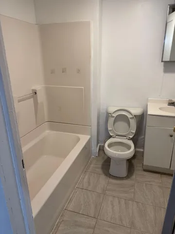 a bathroom with a sink a toilet and bathtub