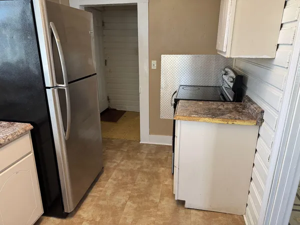 a kitchen with a refrigerator and microwave
