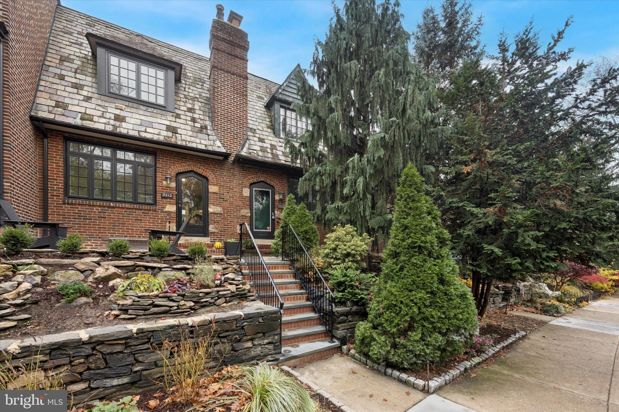 a front view of a house with trees